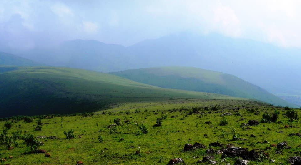 Green Deomali peak against a hazy sky